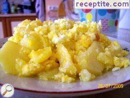 Fried potatoes with watering egg and cheese