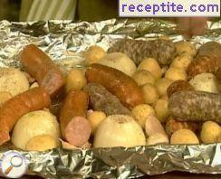 Three types of sausages, potatoes and onions in foil