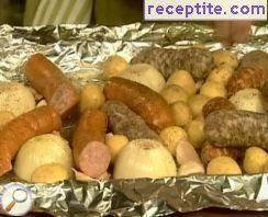 Three types of sausages, potatoes and onions in foil Three types of sausages, potatoes and onions in foil