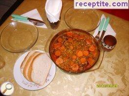 Pork with mushrooms and potatoes in a glass pot