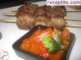 Meatballs on skewers with tomato sauce