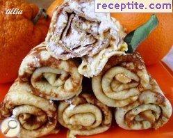 Orange pancakes stuffed with cottage cheese