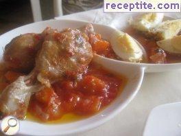 Chicken in tomato sauce with fried eggs