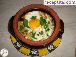 Eggplant with eggs and feta cheese in a pot