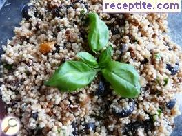 Quinoa salad with olives, dried tomatoes and basil