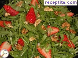 Fresh salad with arugula, strawberries and nuts