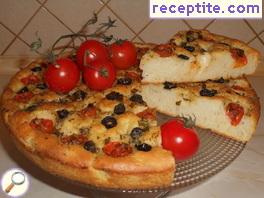 Focaccia with cherry tomatoes, olives and oregano