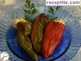 Stuffed peppers with eggs, feta cheese and cheese in the oven