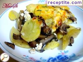 Dish with zucchini, potatoes and mushrooms in the oven