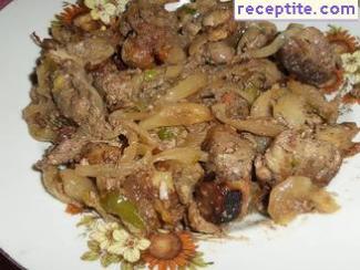 Chicken liver with onions in a pan